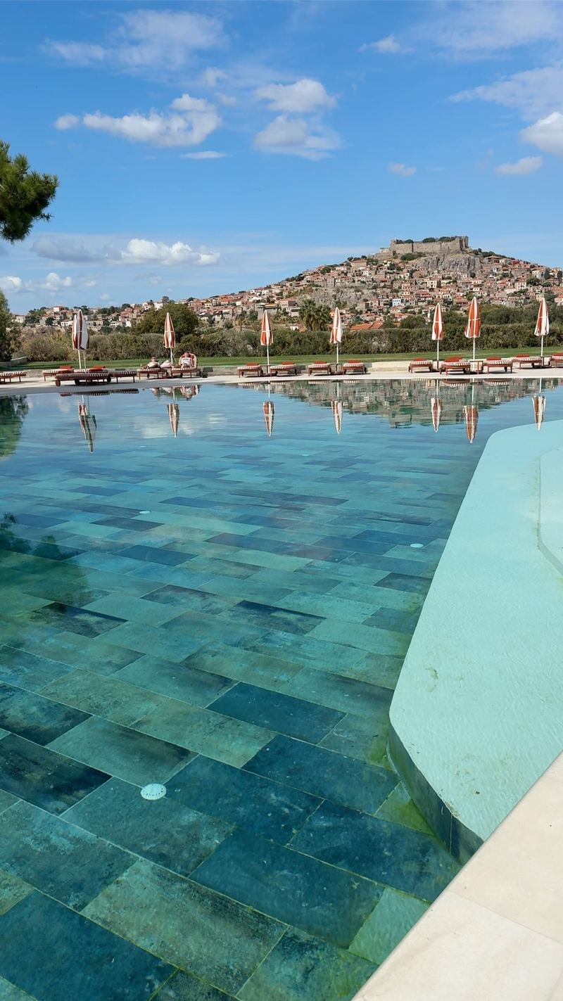 Basen hotelu Delfinia z widokiem na zamek w Molyvos